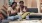 2 people sitting on a couch eating popcorn Taryn at 401 luxury apartments for rent Raleigh NC