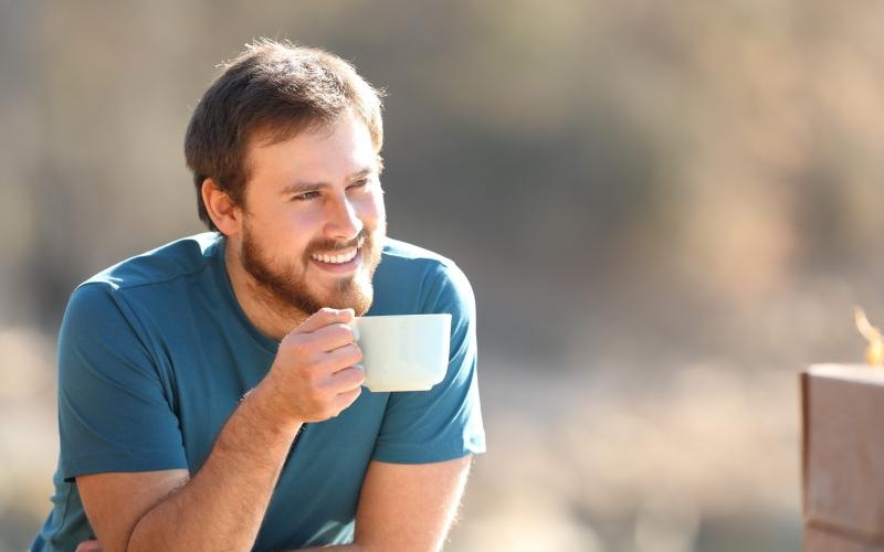 a man holding a cup