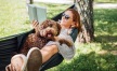 a person in a hammock reading with a dog - Taryn at 401 brand new apartments Raleigh NC