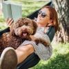 person with dog laying in a hammock together Taryn at 401 luxury apartments for rent Raleigh NC